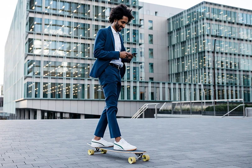 Man Using Phone On Skateboard